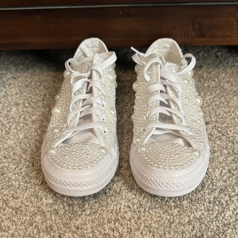 Pearl covered white converse shoes.
